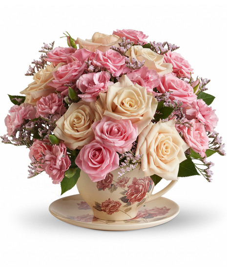 Pink and cream flowers in a reusable teacup and saucer