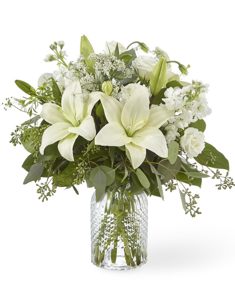 White Sympathy Flowers in a Clear Glass Vase