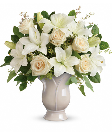 White lilies and cream roses in a ceramic vase