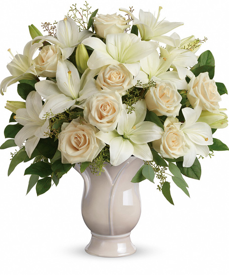 White lilies and cream roses in a ceramic vase