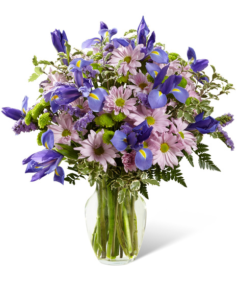 Irises and daisies in a glass vase