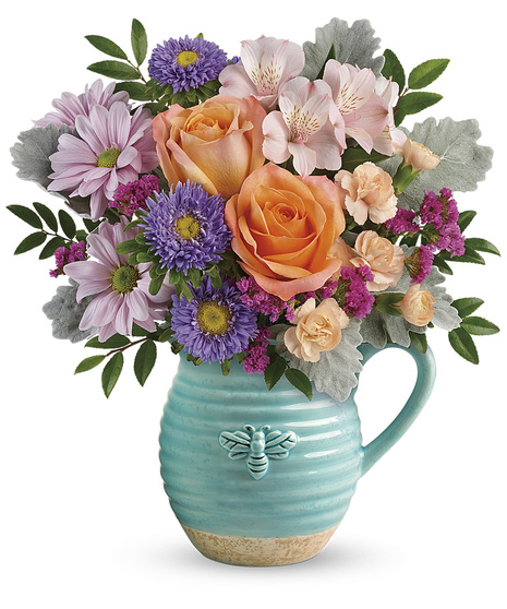 Spring flowers in a cute pitcher