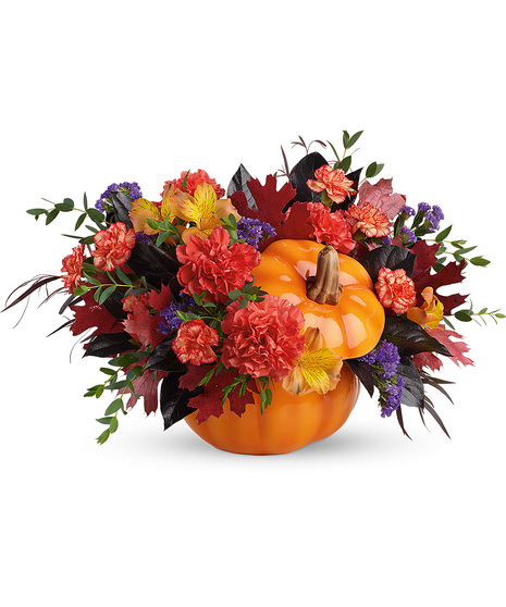 Fall flowers arranged in an orange ceramic pumpkin with lid