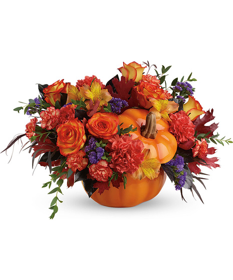 Fall flowers arranged in an orange ceramic pumpkin with lid