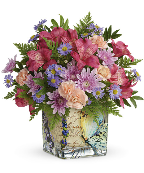 Fresh flowers arranged in a vintage butterfly cube