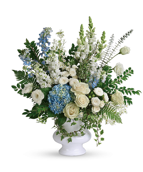 White and blue funeral flowers in a white vase