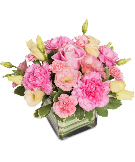 Pink and yellow flowers in a cube vase